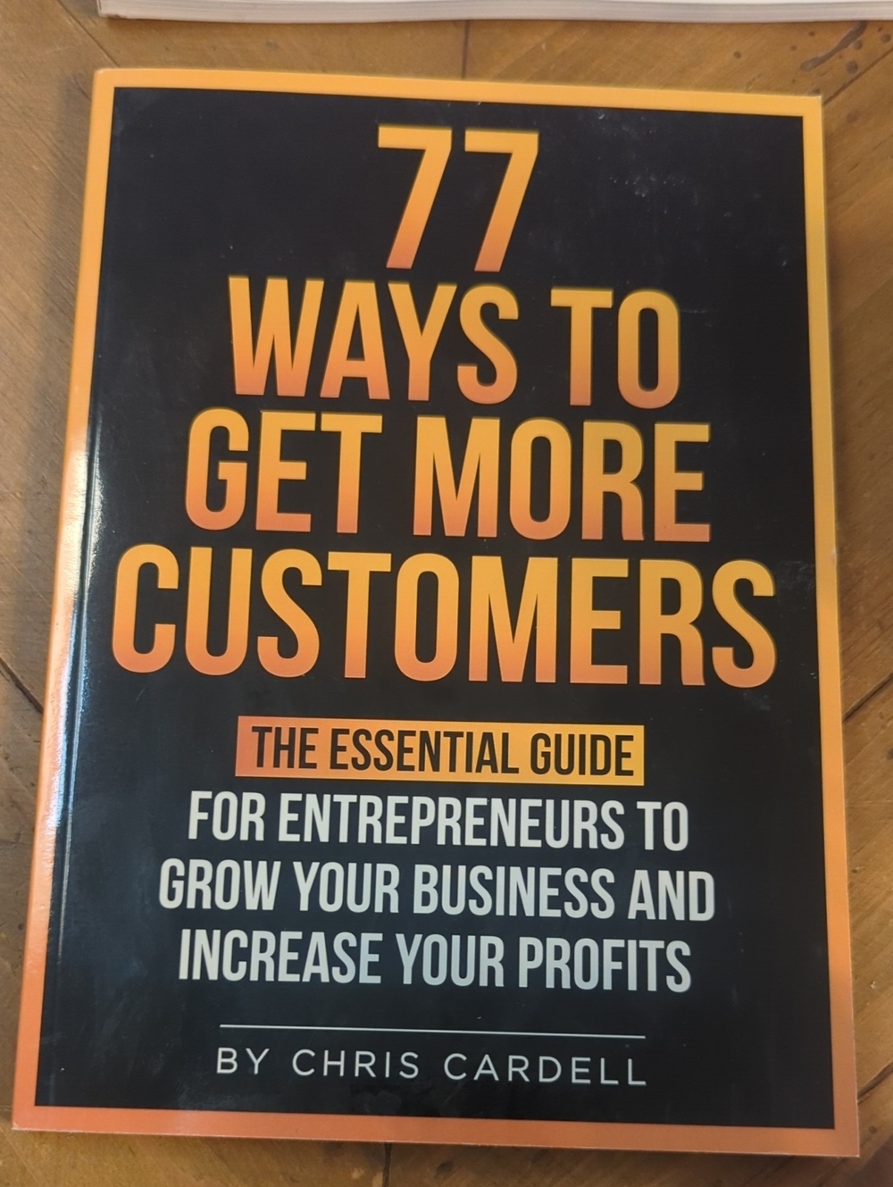 77 Ways To Get More Customers - Black & Orange Business Guide